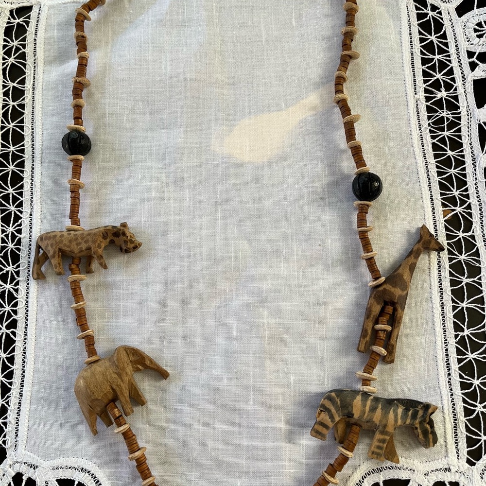 Hand carved Safari wood animal necklace.  15”.  Glass bead accent.